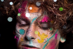 Colourful creative makeup with a sprinkling of glitter and twinkly lights