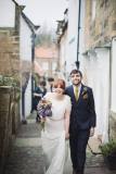 Bride and Groom walking to their wedding at Robin Hoods Bay.  Image by Sasha Lee Photography