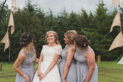 Bride Steph with her bridesmaids having a giggle after the wedding reception at The Lordstone, North Yorkshire.