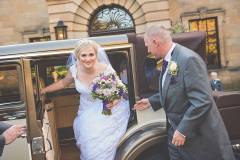 Bride Gemma and her father getting out of the wedding car. Makeup by Gemma Rimmington.