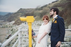 Bride and Groom walking to their wedding at Robin Hoods Bay.  Image by Sasha Lee Photography