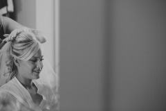Bride Hannah getting the finishing touches done to her hair and makeup before her wedding at Wrays Barn, Great Ayton.