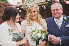 Bride Steph looks beautiful, stood between the mother of the bride and the father of the bride. Wedding reception at The Lordstones, North Yorkshire. Makeup by Gemma Rimmington.