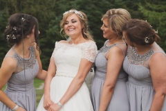 Bride Steph with her bridesmaids having a giggle after the wedding reception at The Lordstone, North Yorkshire.