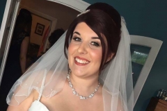 Happy bride Nicola is dressed and ready to set off to her wedding. Her bridal makeup is polished and glamourous.