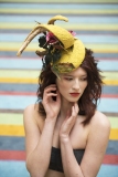 Editorial style makeup, bright orange lips, flawless foundation and a high fashion headpiece.  Photoshoot took place at Tate Modern London