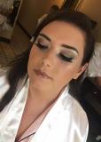 Bride Natalie wears a soft brown eyeshadow, winged eyeliner and a nude gloss.