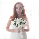 Red head bride with flawless skin and copper eye makeup.