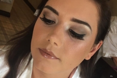 Bride Natalie wears a soft brown eyeshadow, winged eyeliner and a nude gloss.