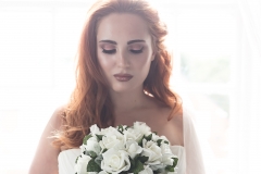 Red head bride with flawless skin and copper eye makeup.