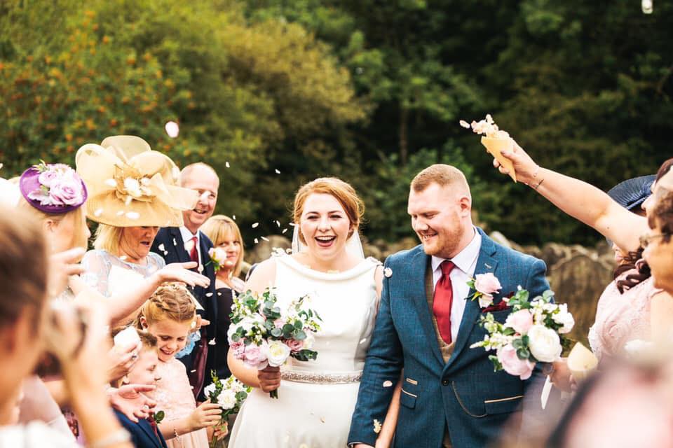 Stunning bridal makeup for bride Lauren who is smiling with her bridal party 