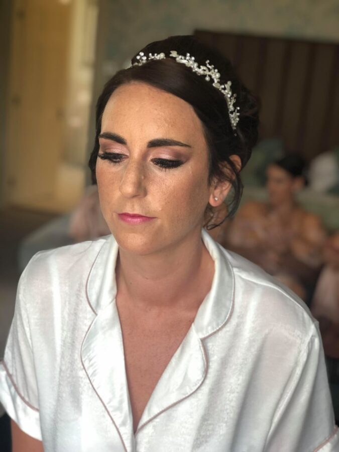 Bridal makeup showing glowing, freckly skin and well maintained brows for wedding at Storrs Hall, the Lakes District.